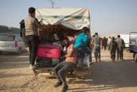 Syrian refugees who had been living in Lebanon arrive in an opposition-controlled area in north-western Syria via the Aoun al-Dadat crossing. Photograph: Ali Haj Suleiman/The Guardian